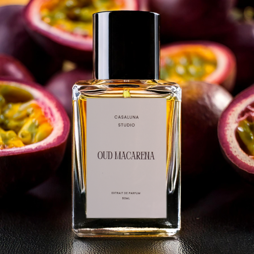 Perfume bottle labeled 'Oud Macarena' surrounded by halved passion fruits.