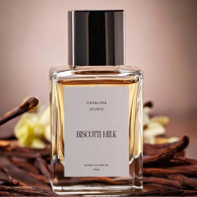 Perfume bottle labeled 'Biscotti Milk' with vanilla pods in the background.