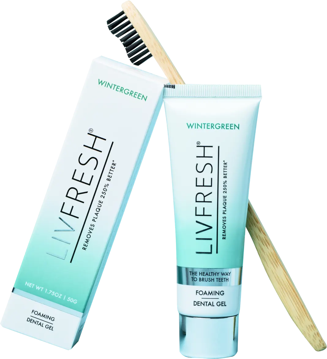 Toothpaste tube and box with a bamboo toothbrush.