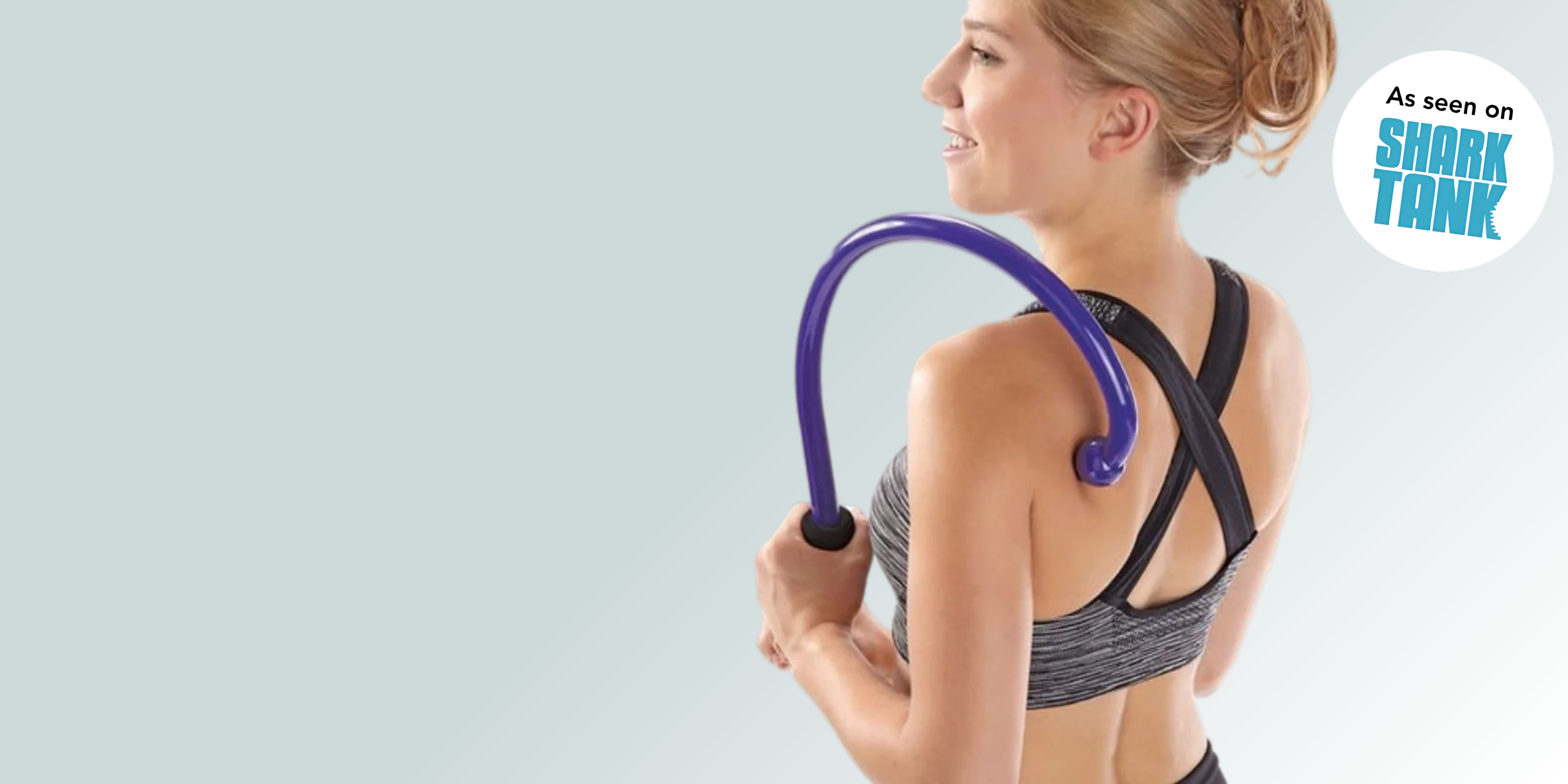 Person using a purple massage tool on their back, 'As seen on Shark Tank' logo visible.