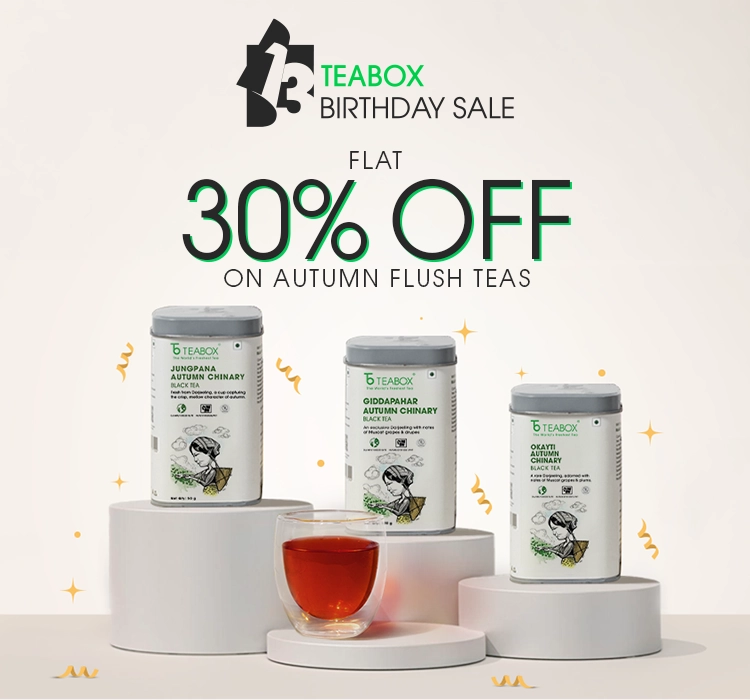 An advertisement for Teabox's birthday sale, featuring three tins of Autumn Flush tea and a glass of tea.