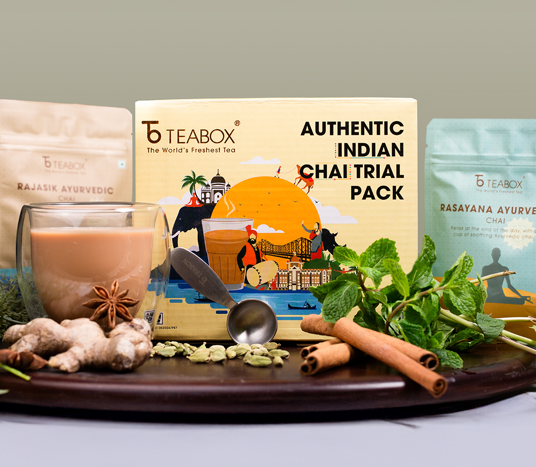 Teabox Indian chai trial pack with spices, herbs, and a glass of chai.