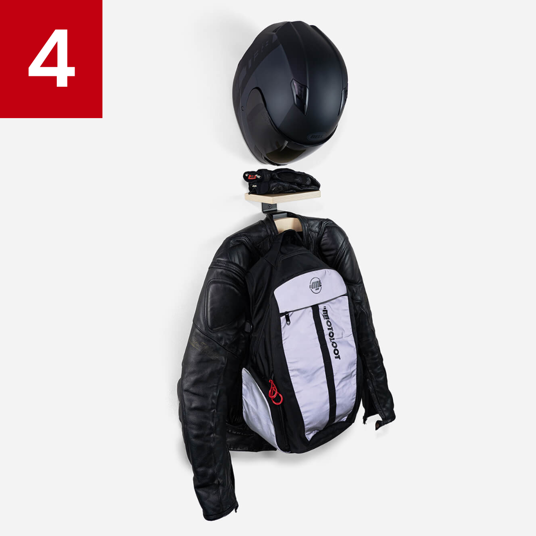 Motorcycle gear on a wall, including helmet, gloves, jacket, and backpack.