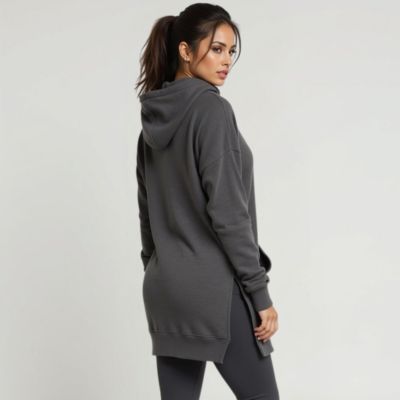 Person wearing a dark hoodie and leggings, turned slightly sideways.