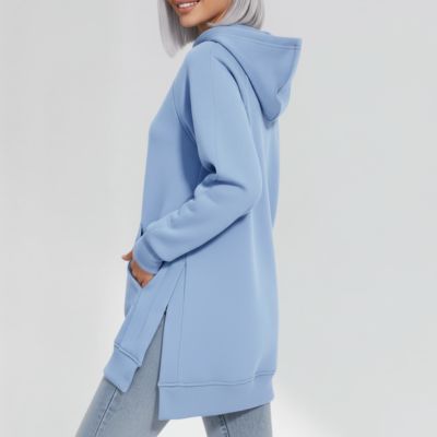 Person wearing a light blue hoodie and jeans, posing sideways.