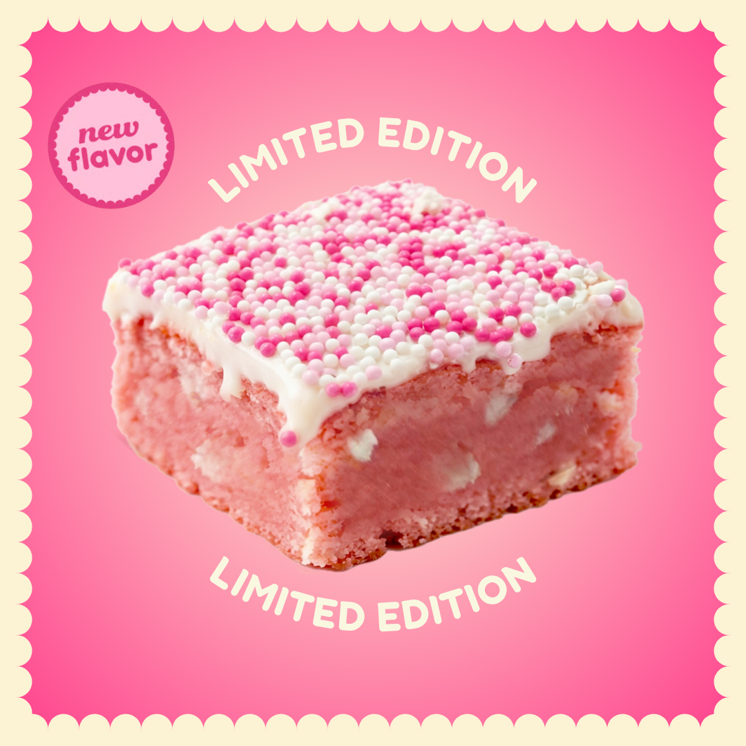 A pink cake square with white frosting and pink and white sprinkles on a pink background.