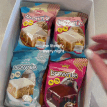 Box with assorted packaged brownies, hand reaching in.