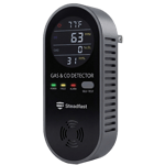 A black digital radon and air quality monitor displaying readings on its screen.