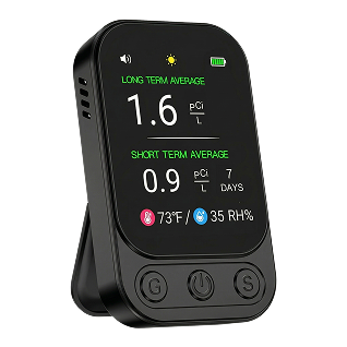 A black digital radon and air quality monitor displaying readings on its screen.
