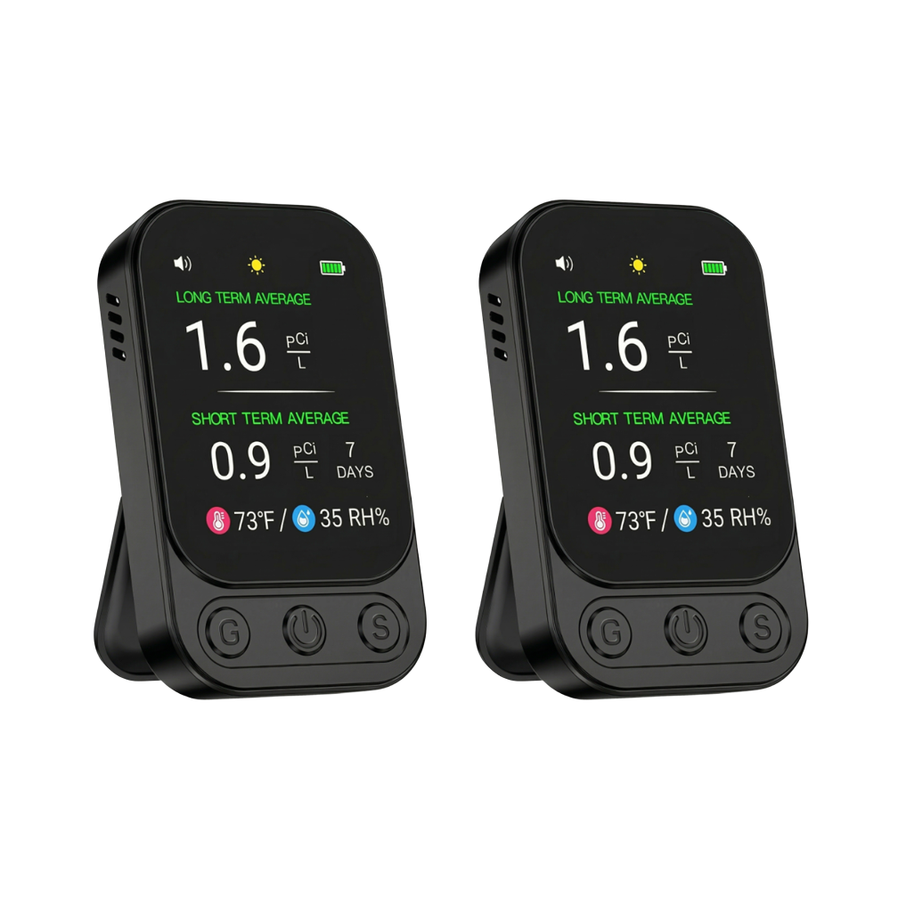 Two identical black digital radon detectors with illuminated screens, standing upright against a white background.