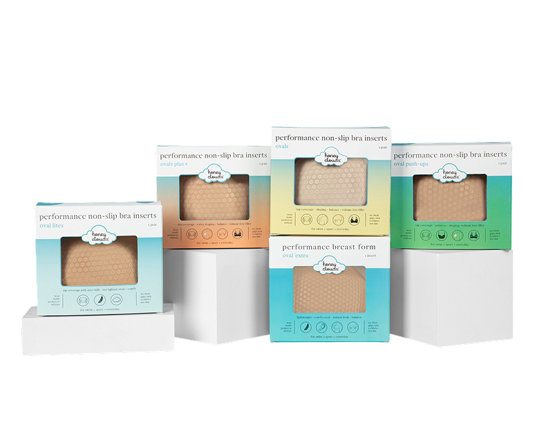 Five boxes of performance non-slip bra inserts on white stands.