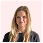 Portrait of a person with long blonde hair against a light pink background.