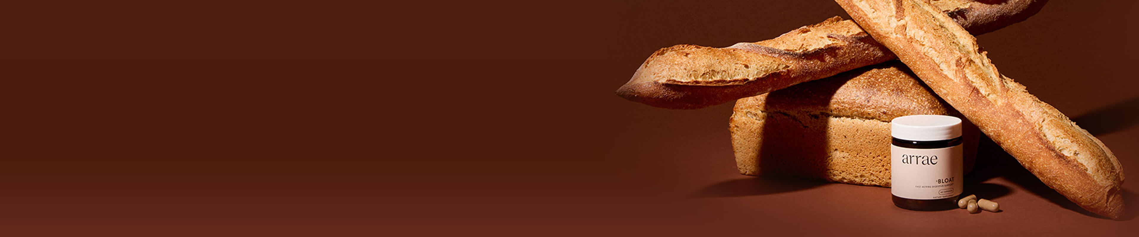 Jar labeled 'arrae' with bread and capsules on a brown background.