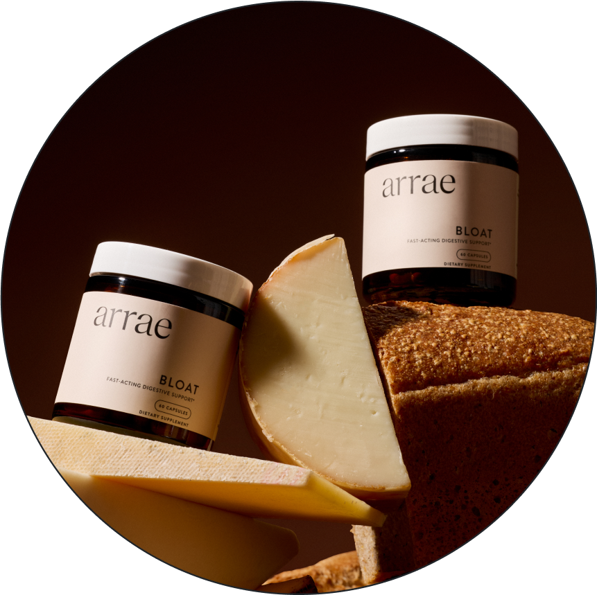 Jar labeled 'arrae BLOAT' on stacked cheese pieces against brown background.
