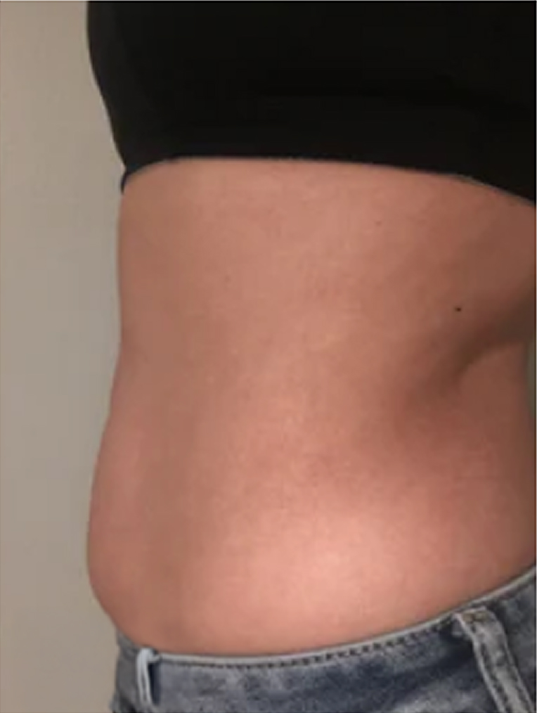 Side view of a person's midsection wearing jeans and a black top.