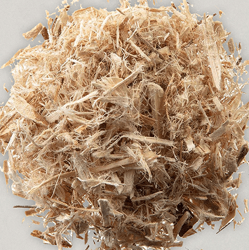 A pile of light brown wood shavings on a gray background.
