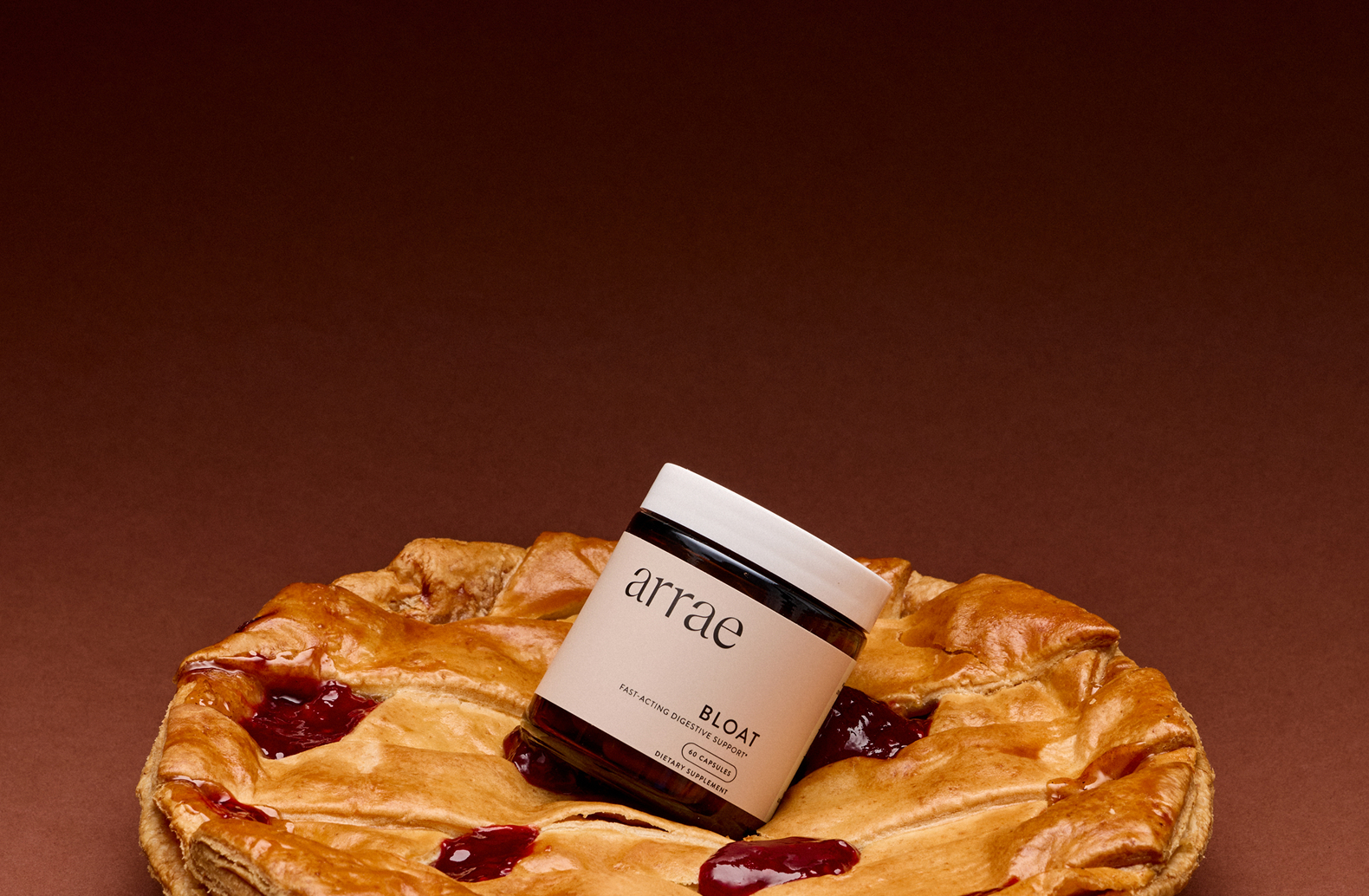 A jar labeled 'arrae Bloat' on a pie with a brown background.