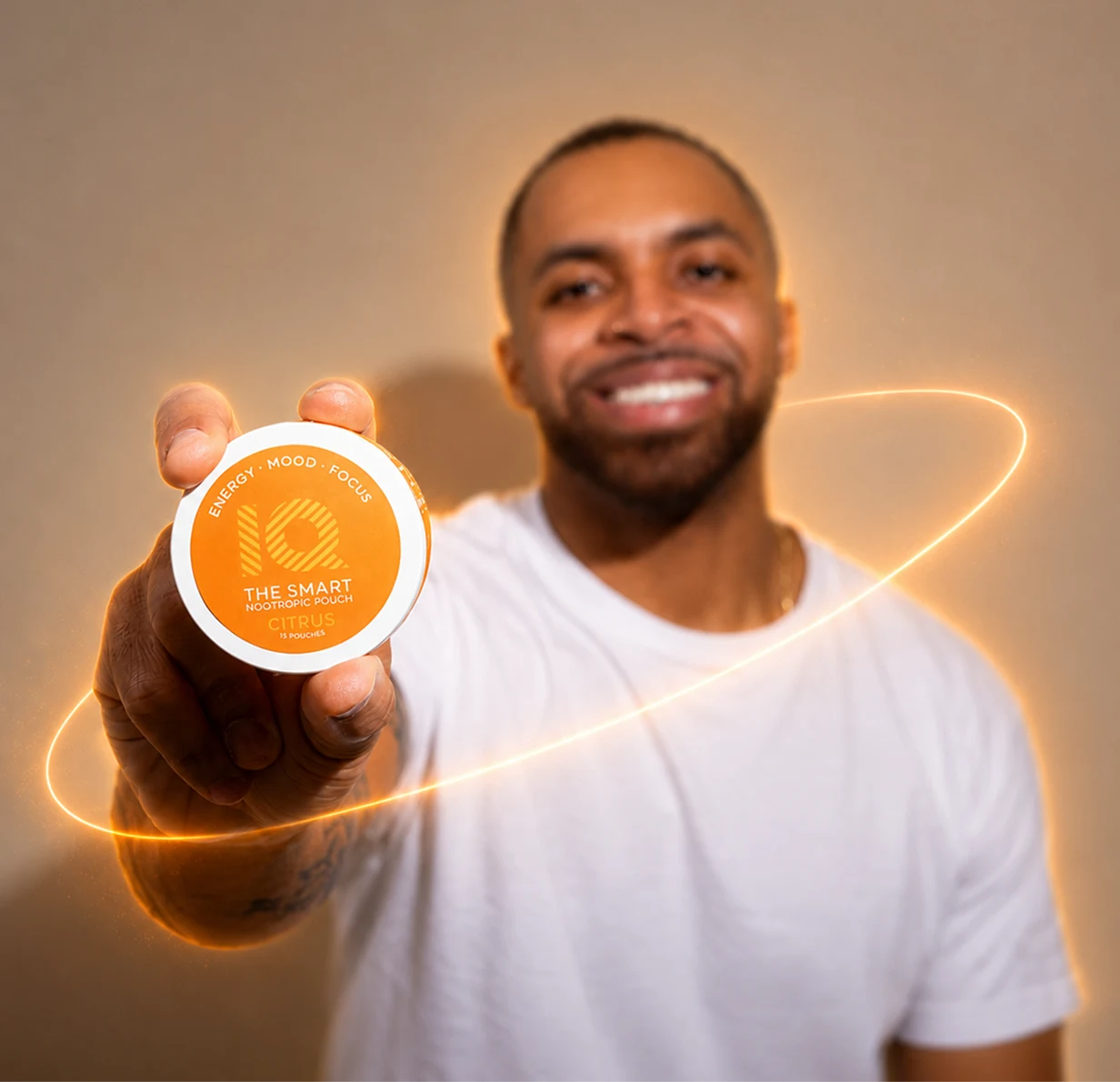 A smiling man holds up a round container of IQ The Smart Nootropic Pouch, citrus flavor.