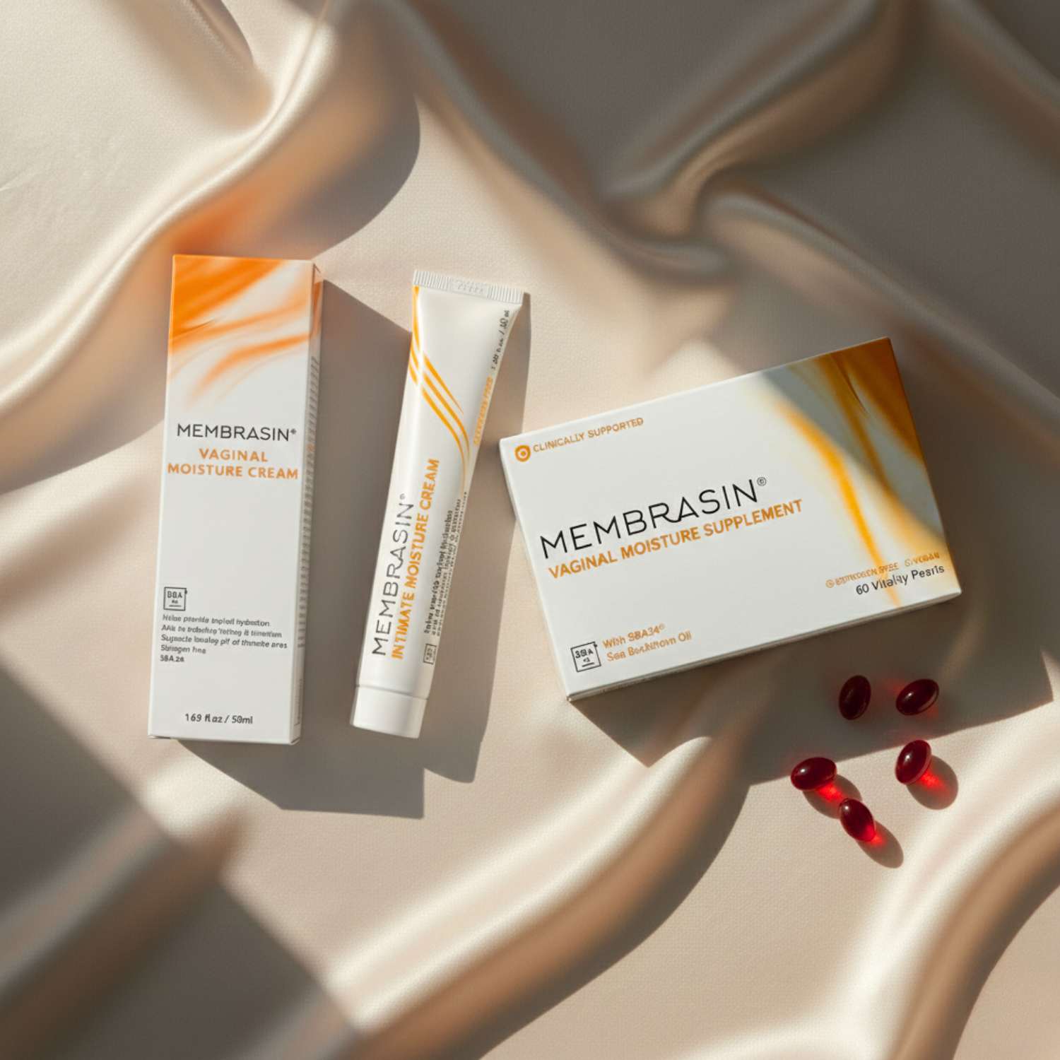Membrasin vaginal moisture cream and supplement products displayed on a draped, silky, beige fabric.
