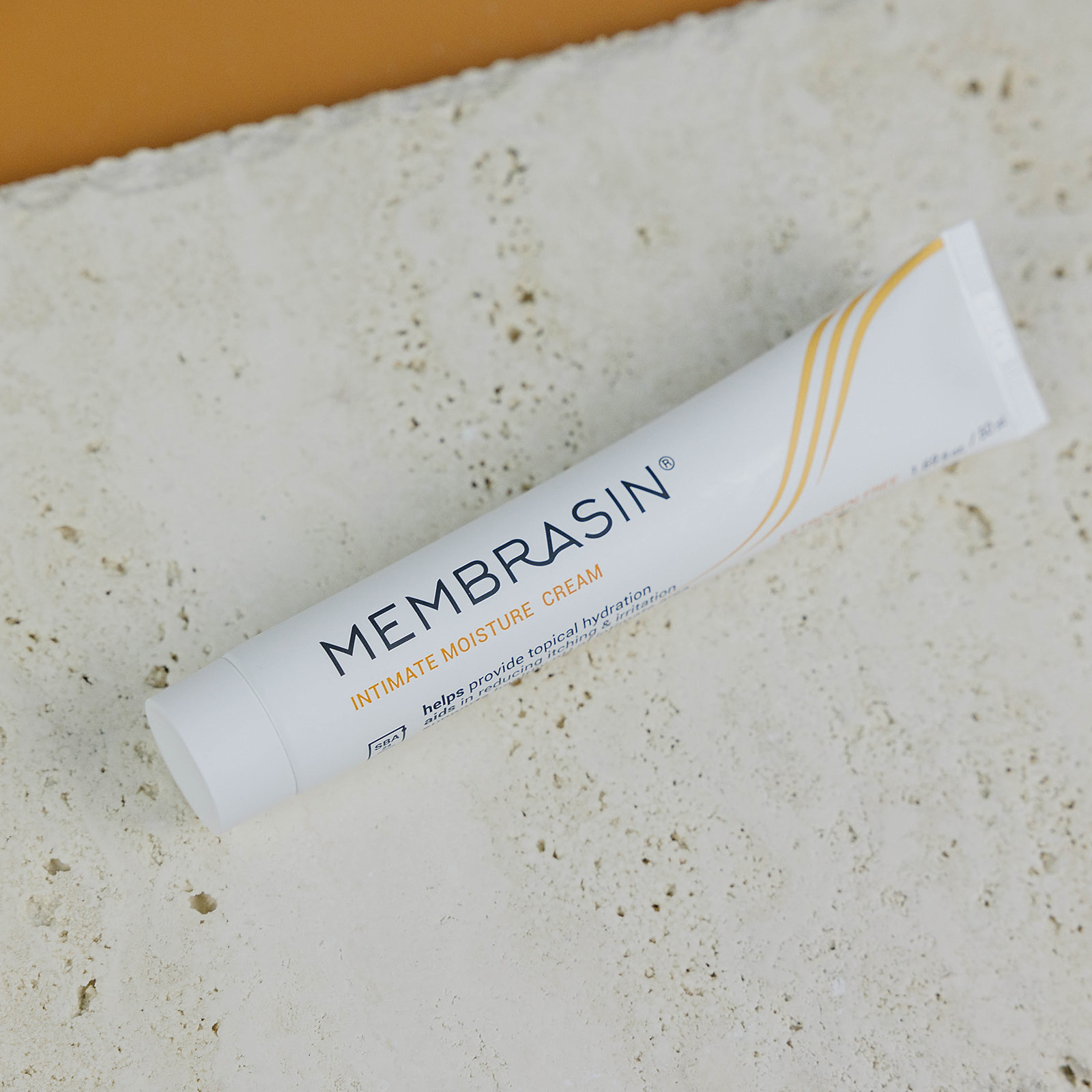 Tube of Membrasin intimate moisture cream on a textured surface.