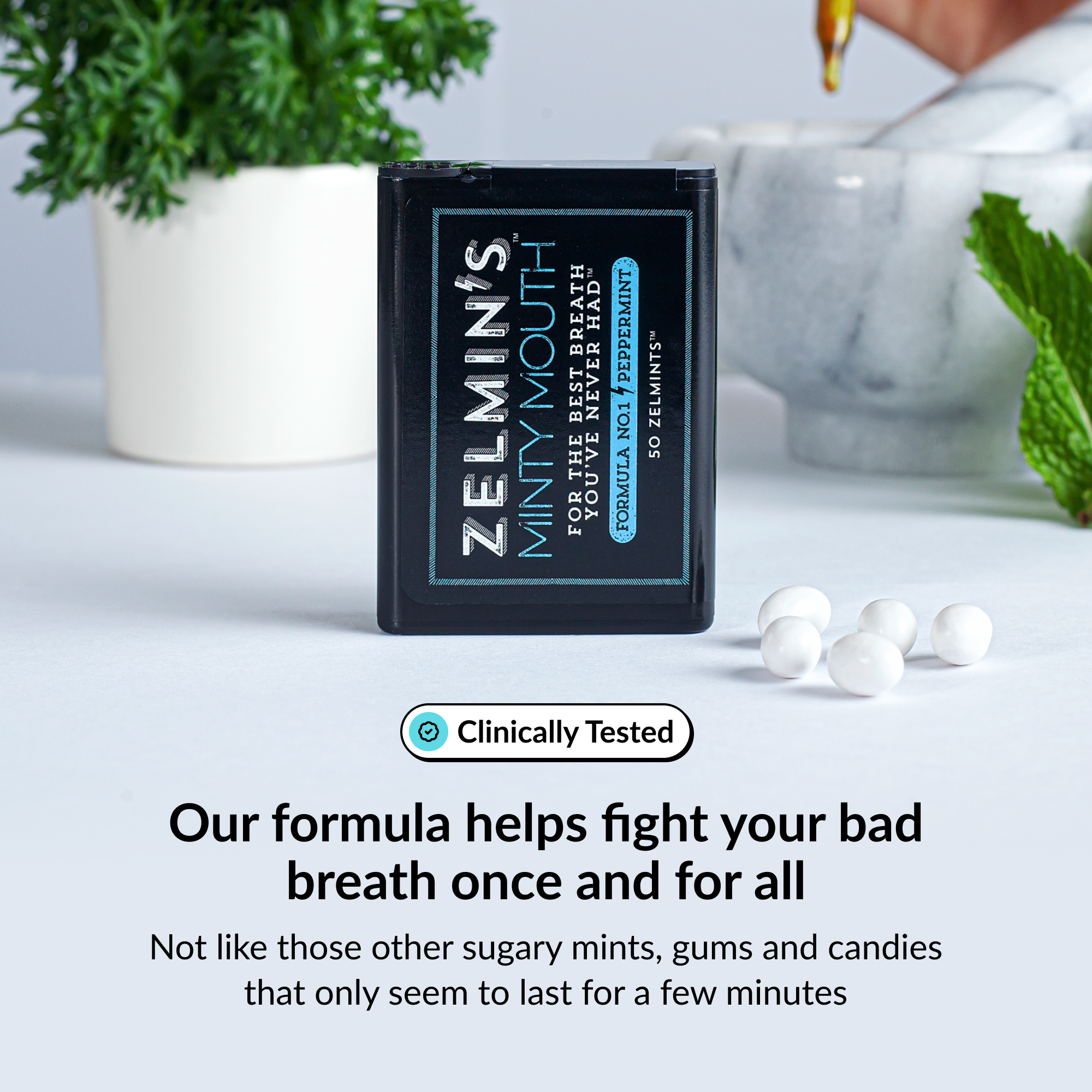 Mint container with text, surrounded by white mints and green leaves.