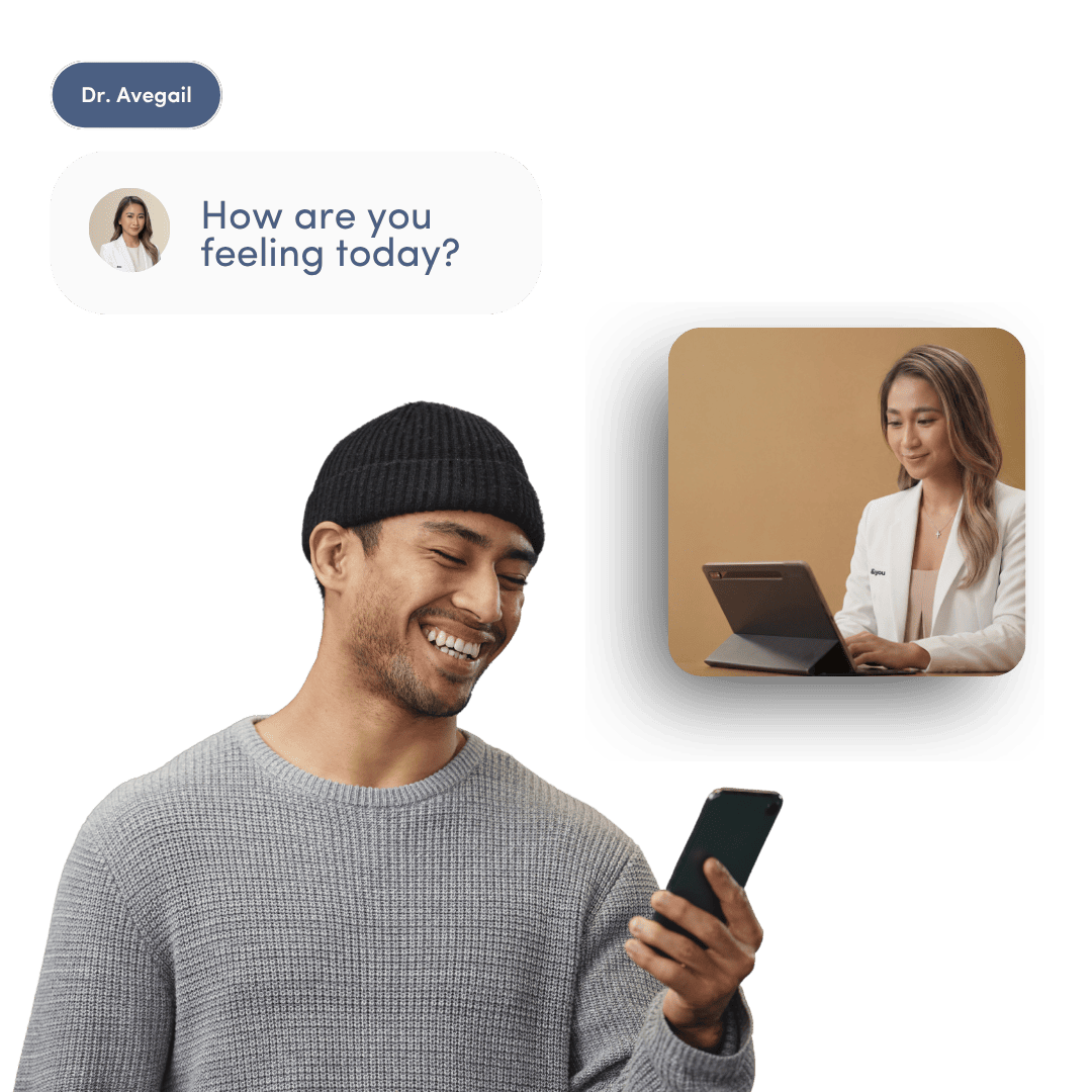 A man smiling at his phone, which displays a chat message and video call with a doctor.