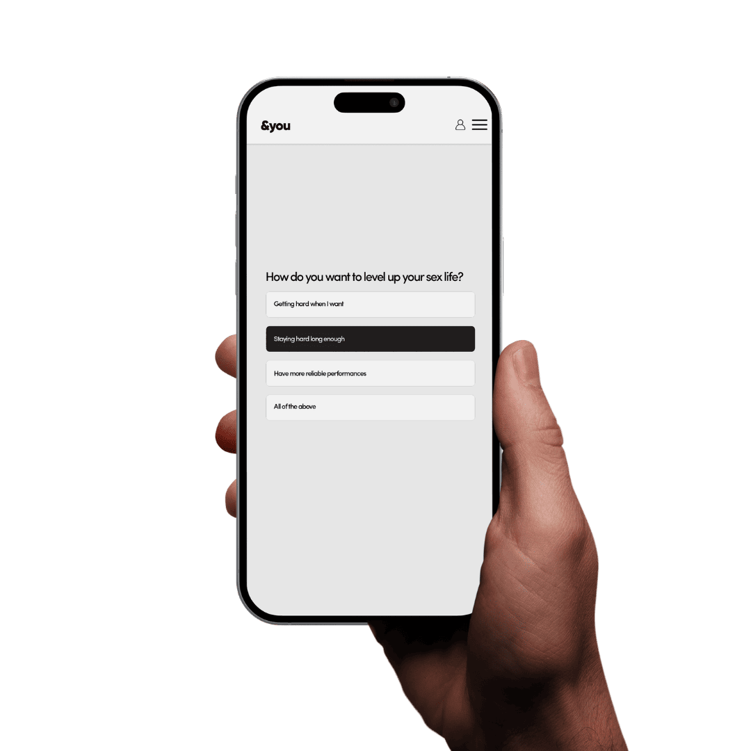 A hand holds a smartphone displaying a website with a quiz about improving one's sex life.