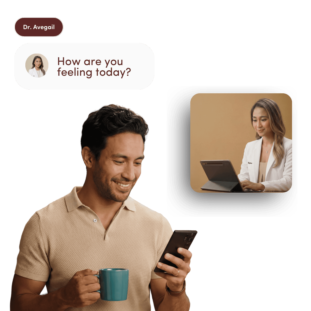 A smiling man holds a mug and phone, having a virtual telehealth consultation with a female doctor.