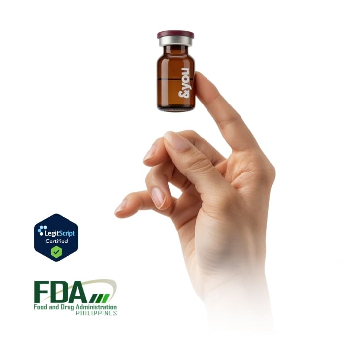 A hand holding a small brown vial labeled '&you', with LegitScript and FDA Philippines logos below.