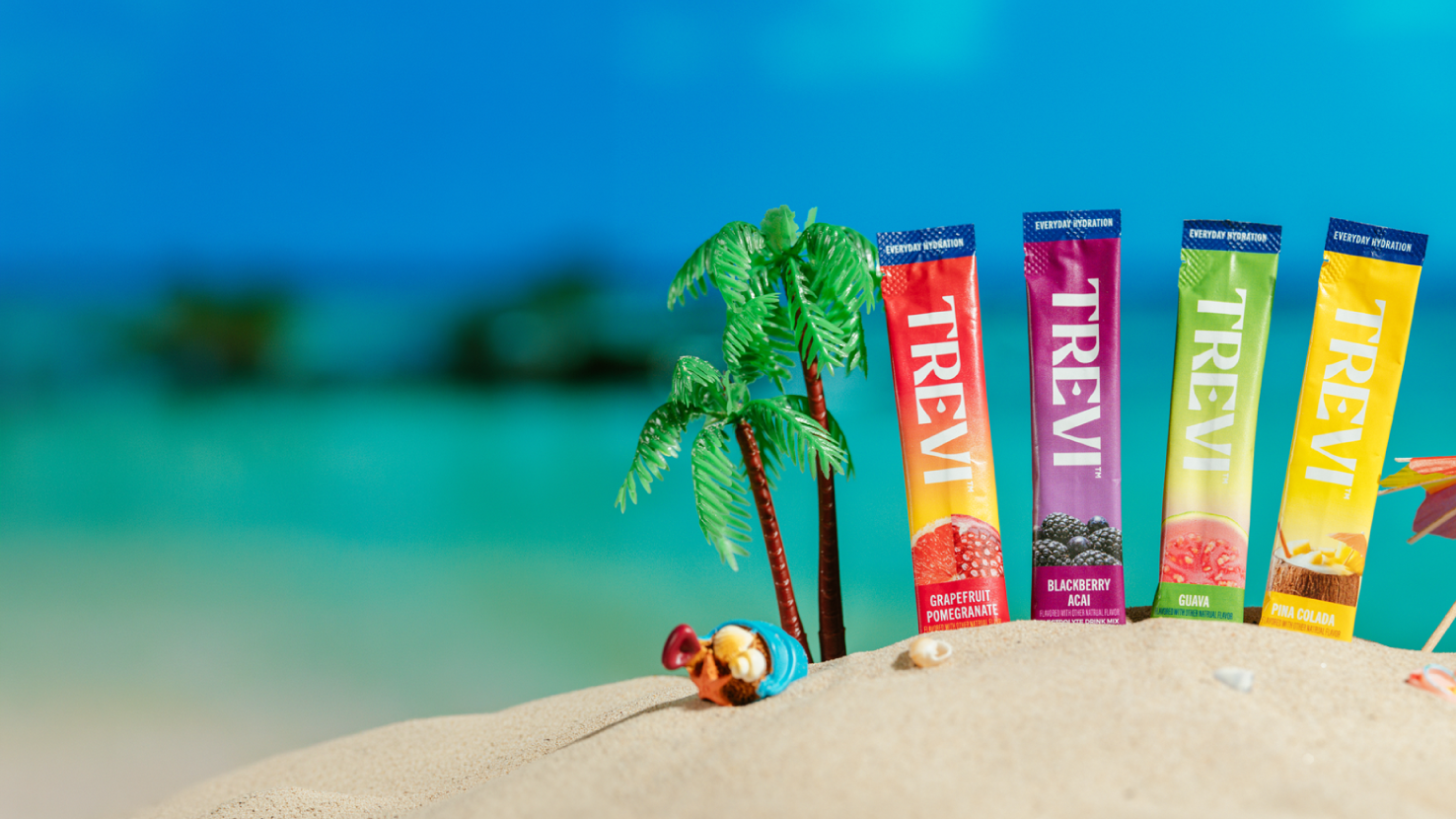 Trevi electrolyte drink mix package surrounded by lemons against a blue sky.