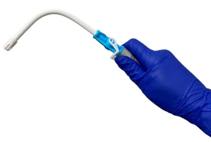 Gloved hand holding a curved medical instrument.