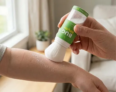 A person applies powder to a forearm using a brush-on applicator labeled 'Bug Brush'.