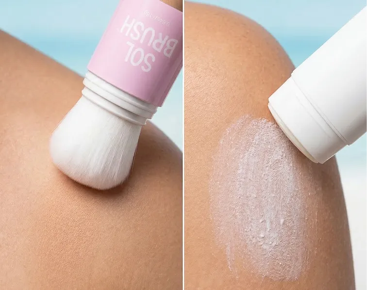 An adult uses a Bug Brush applicator to apply powder to a child's lower leg by a pool.