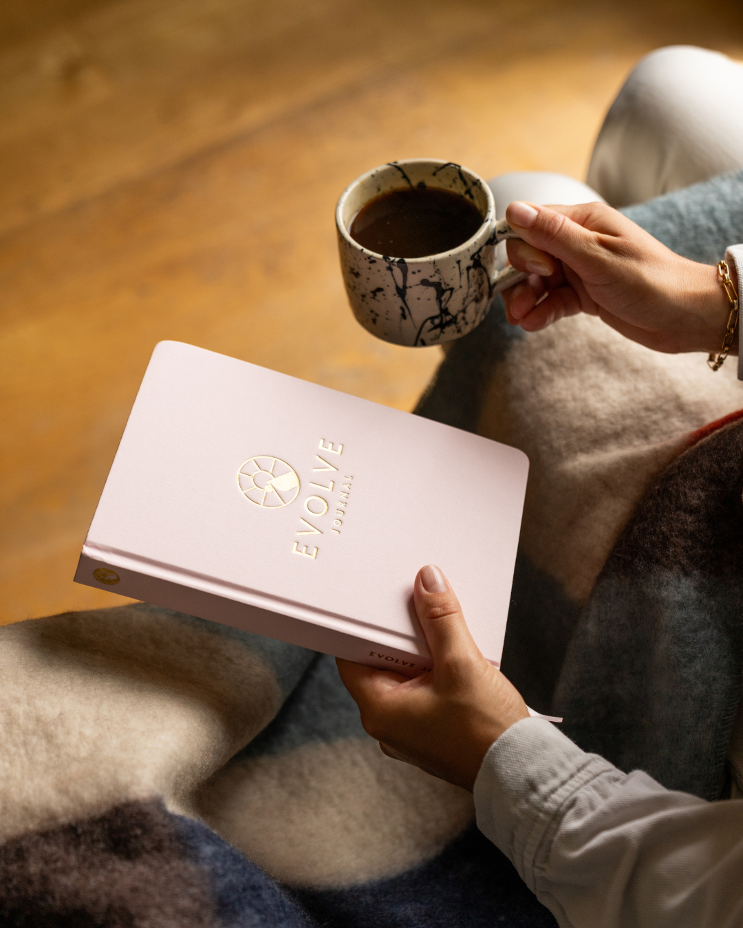 A single palm leaf in a clear glass of water on a white background.