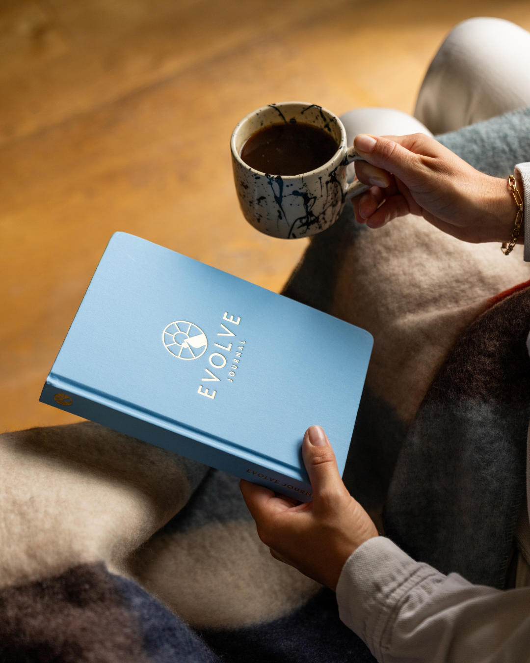A single palm leaf in a clear glass of water on a white background.