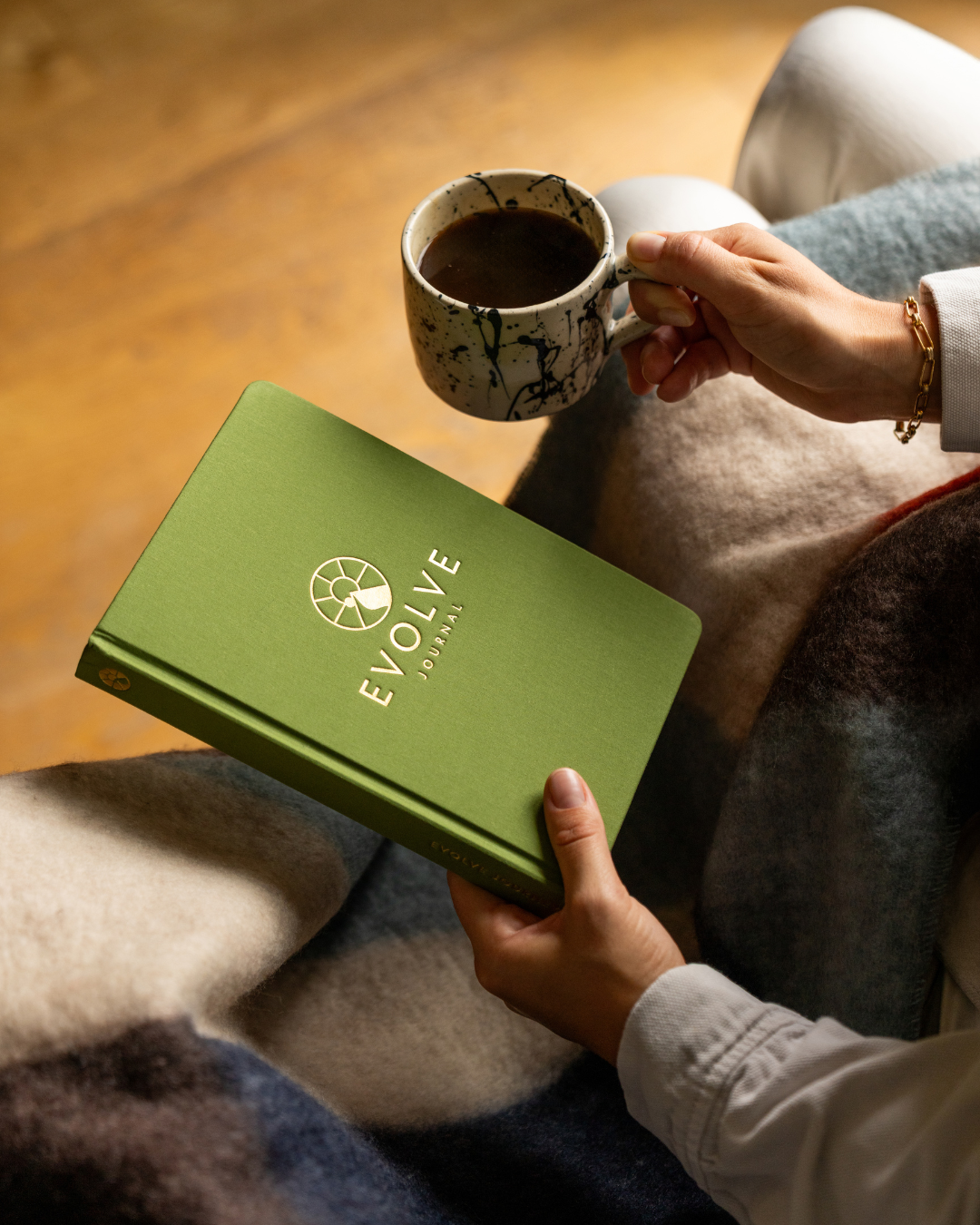 A single palm leaf in a clear glass of water on a white background.