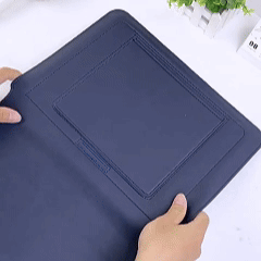 Hands demonstrating a foldable, magnetic tablet cover.