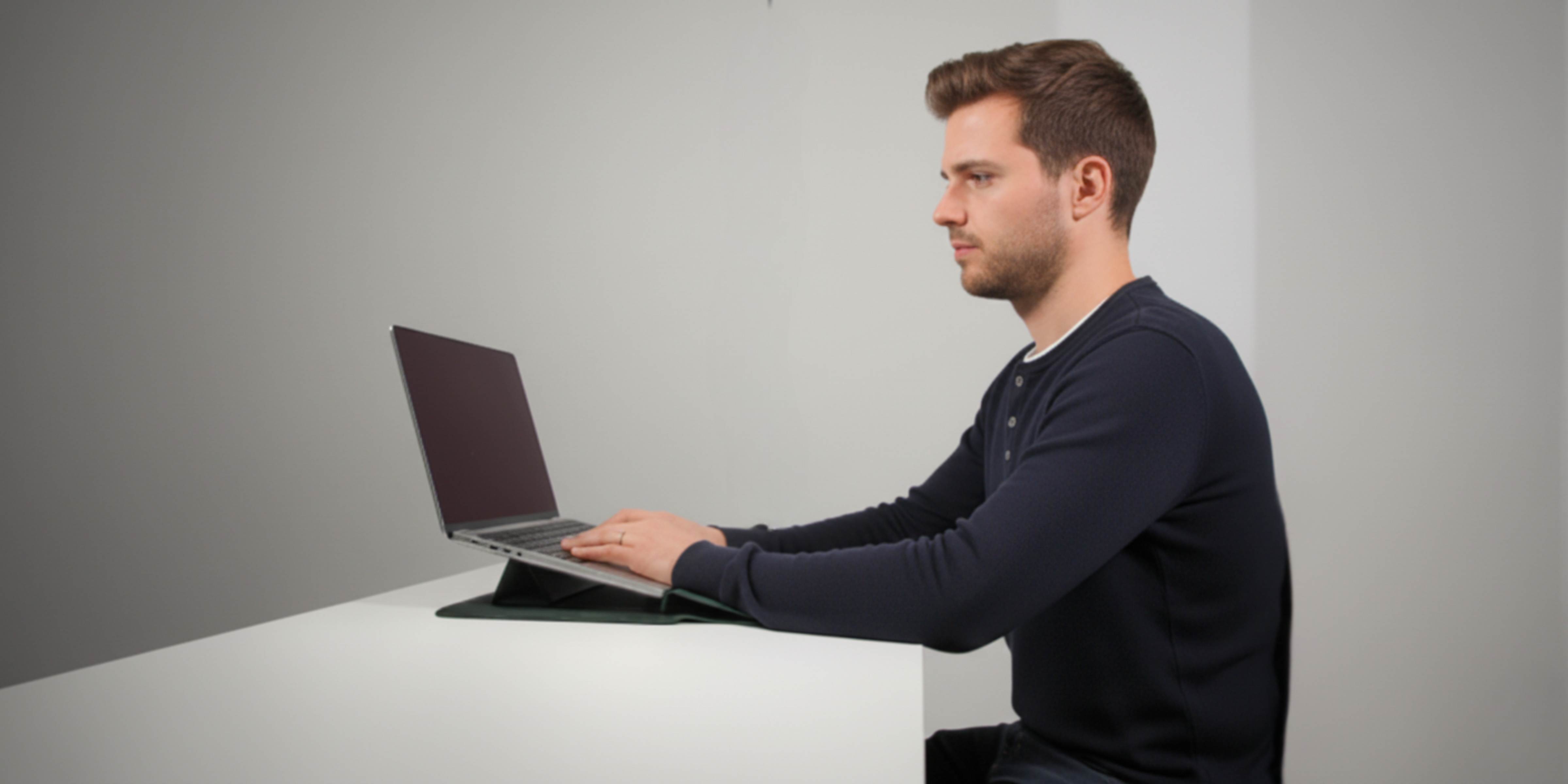 Person typing on a laptop at a desk.