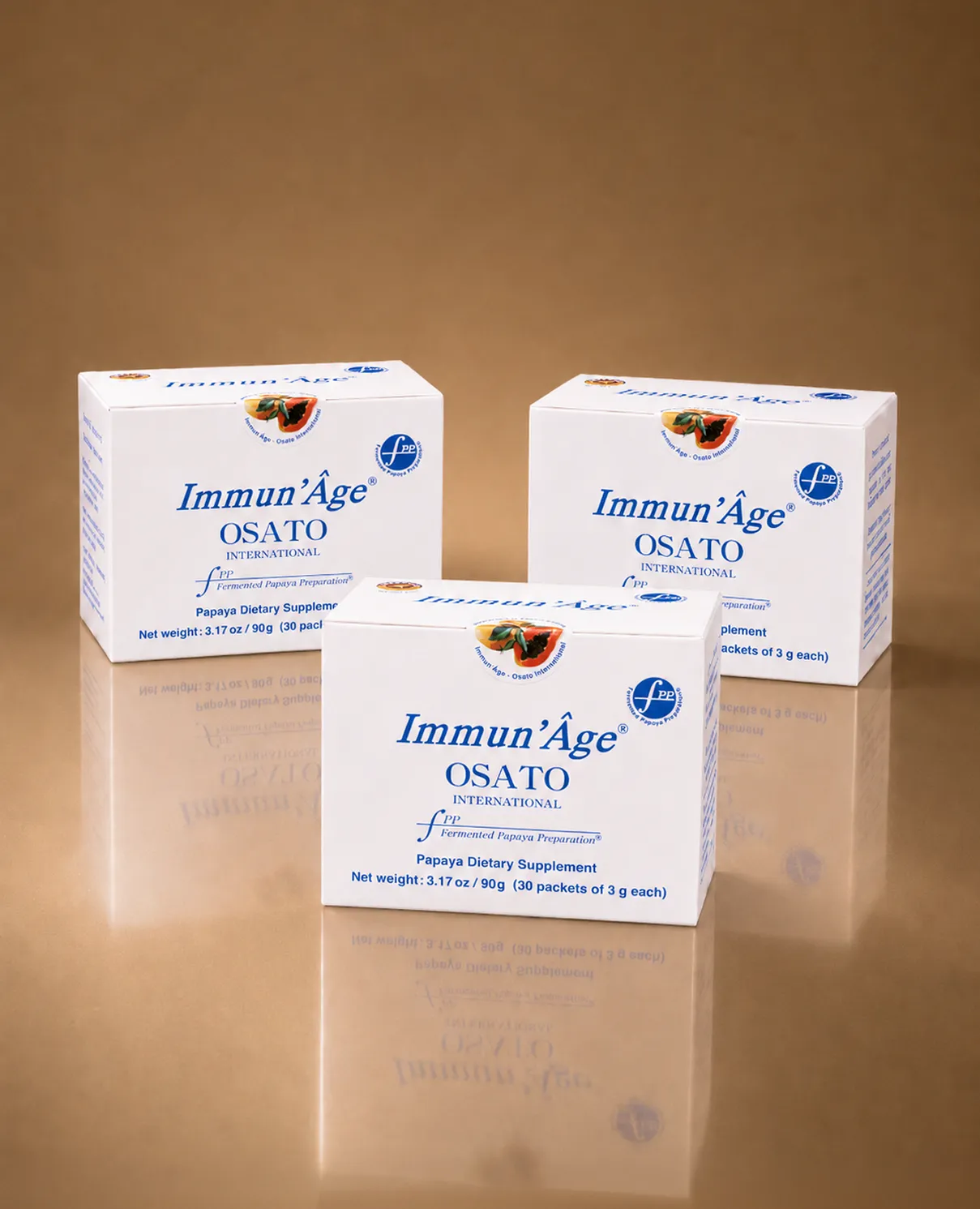 Three white boxes of Immun'Âge Papaya Dietary Supplement on a reflective brown surface.