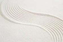 White sand raked into a flowing, curved pattern.