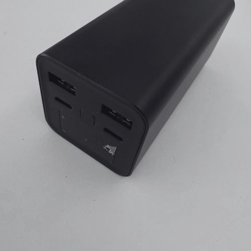 Black rectangular power bank with multiple USB ports on a white background.