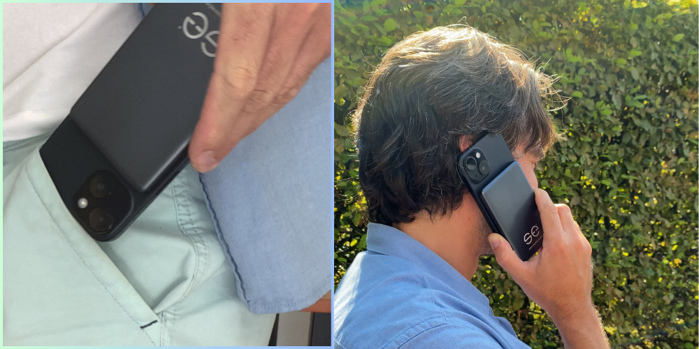 Person holding a smartphone with a case, standing outdoors.