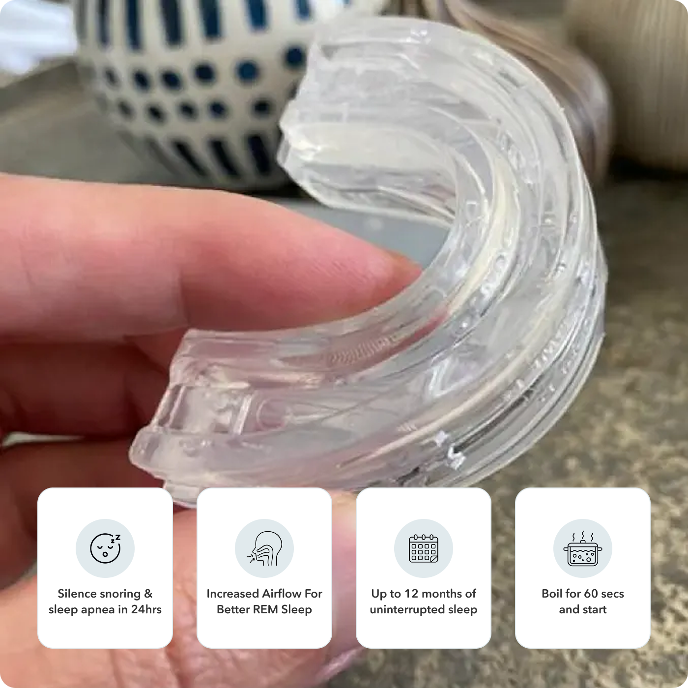 A person holding a transparent anti-snoring mouthpiece with benefits listed in icons below.