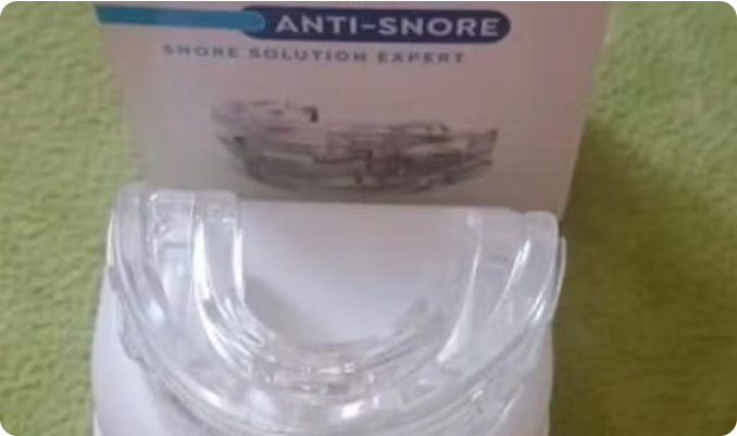 Anti-snore mouthpiece with packaging labeled 'Snore Solution Expert.'
