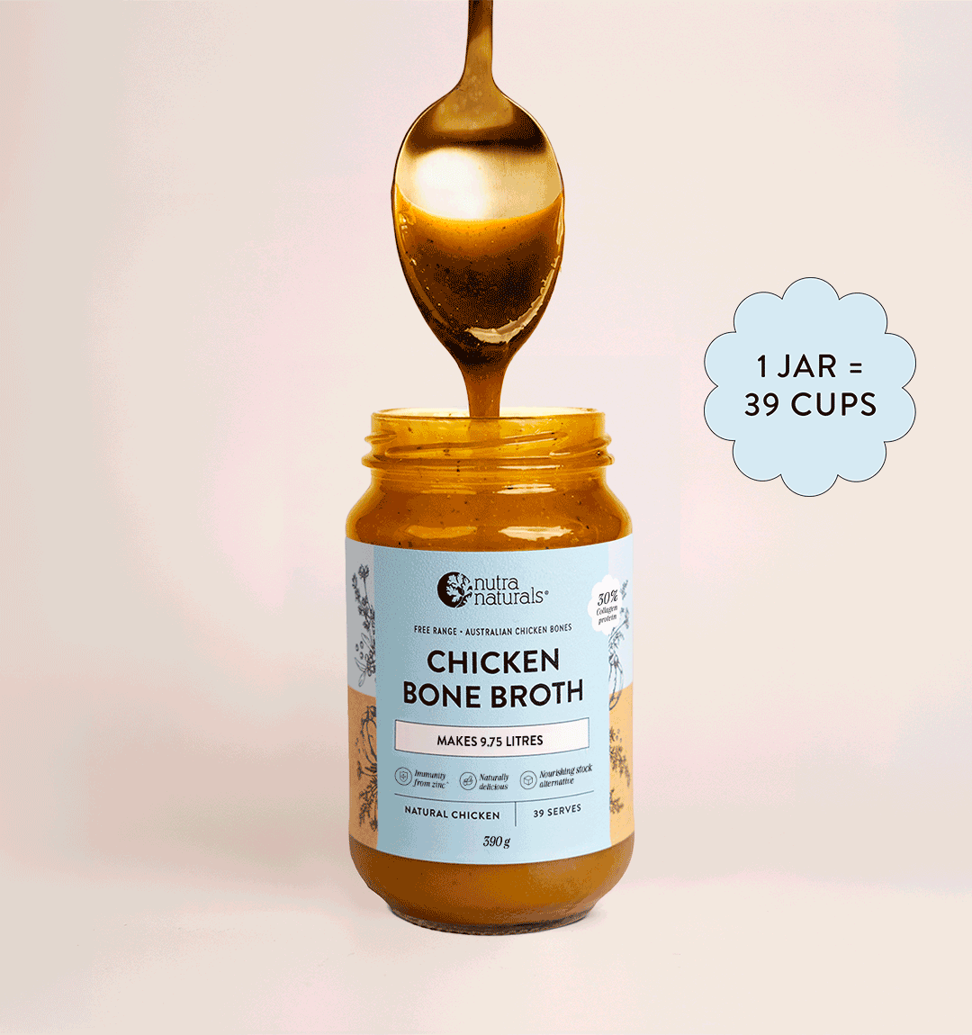 A spoon being dipped into a jar of Nutra Organics Beef Bone Broth concentrate against a plain background.