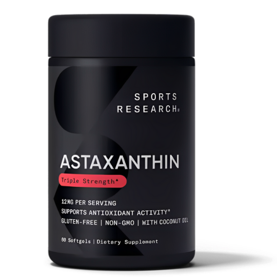 A black bottle of Sports Research Astaxanthin dietary supplement against a black background.