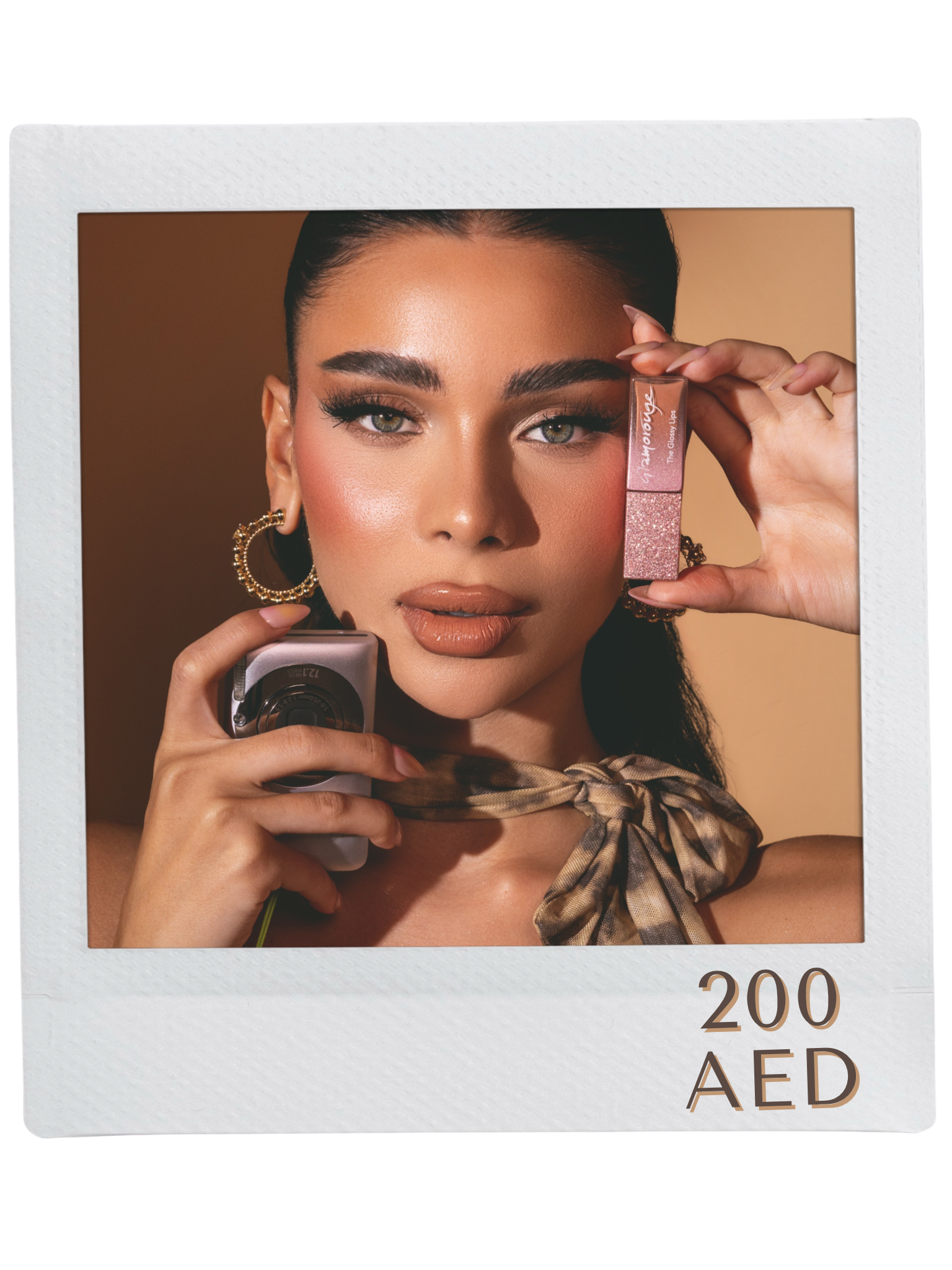 Person holding lipstick and perfume with a brown background.