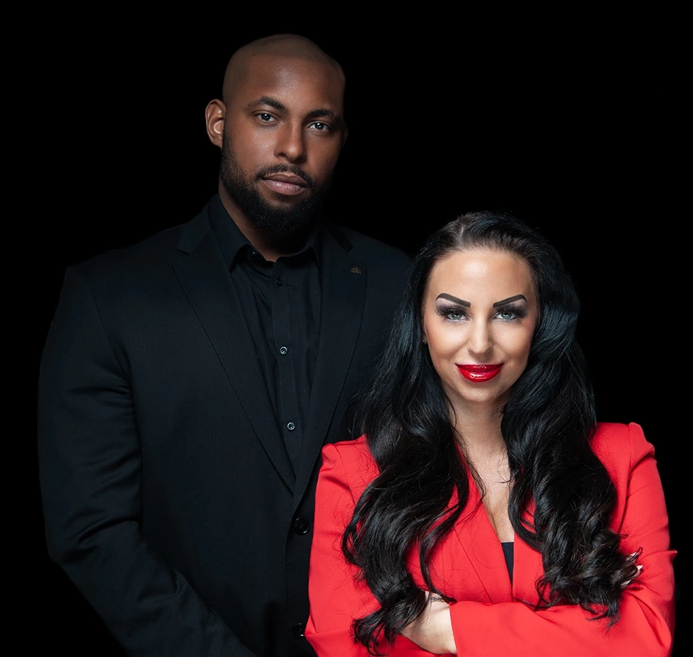 Two people in formal attire against a black background.