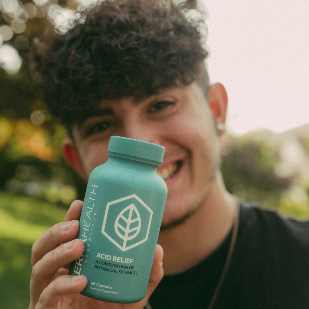 Person holding a bottle labeled 'Acid Relief' with a leaf logo.