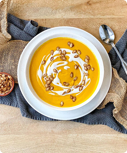 Bright yellow pumpkin soup in a bowl